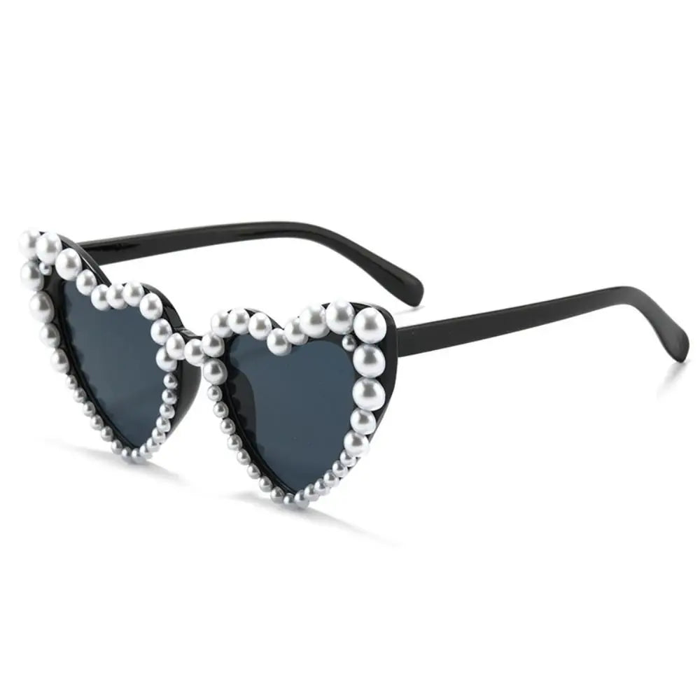 Black heart-shaped sunglasses embellished with white pearls