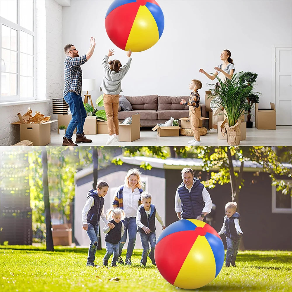 A family is playing with a large red and yellow inflatable ball outdoors in a grassy yard.