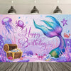 A vibrant mermaid tail backdrop featuring purple and blue sea creatures and sparkling water for a birthday celebration.