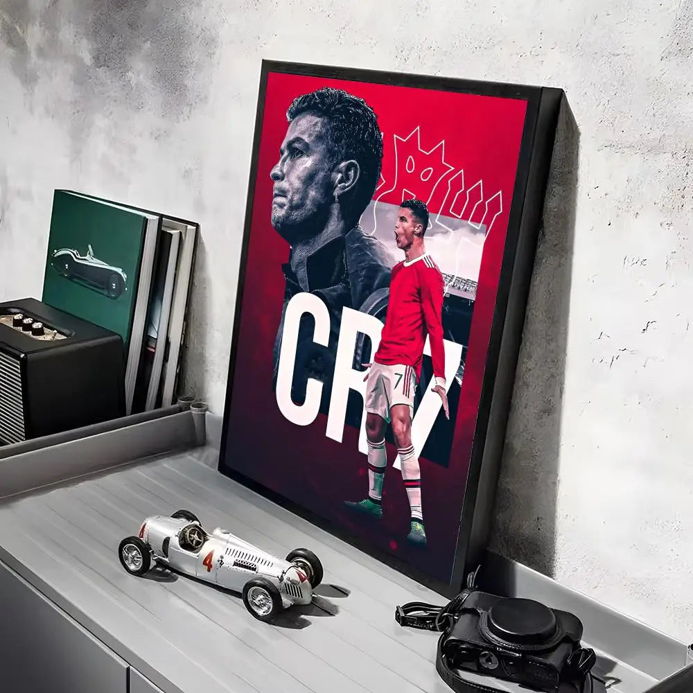 A framed canvas art poster featuring a portrait of Ronaldo in a red shirt and white shorts against a red background.