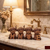 Rustic wooden highland cow and home letter decorative set placed on a marble countertop