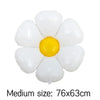A cluster of white foil balloons shaped like daisies with a yellow center.