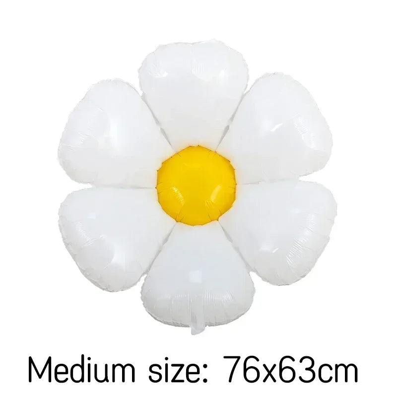 A cluster of white foil balloons shaped like daisies with a yellow center.