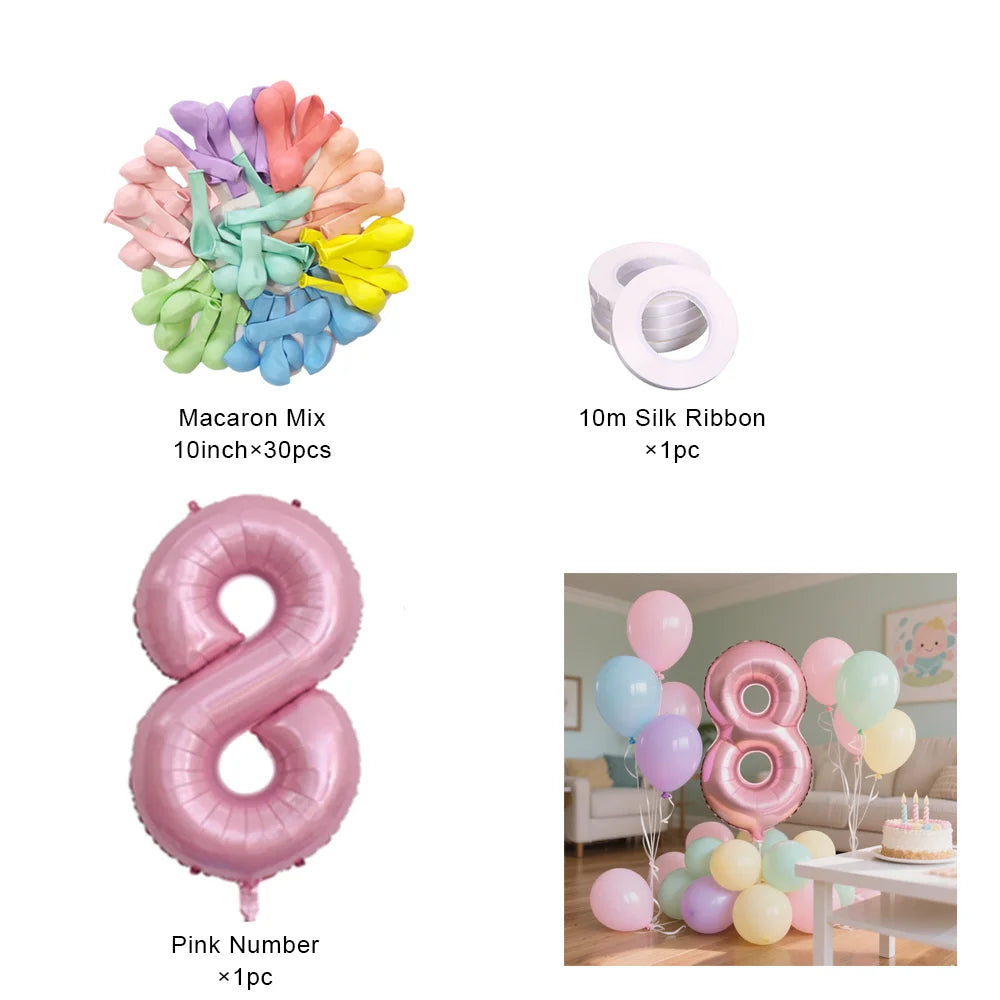 Un set de ballons en papier d'aluminium roses en forme de 8 et diverses rubans colorés.