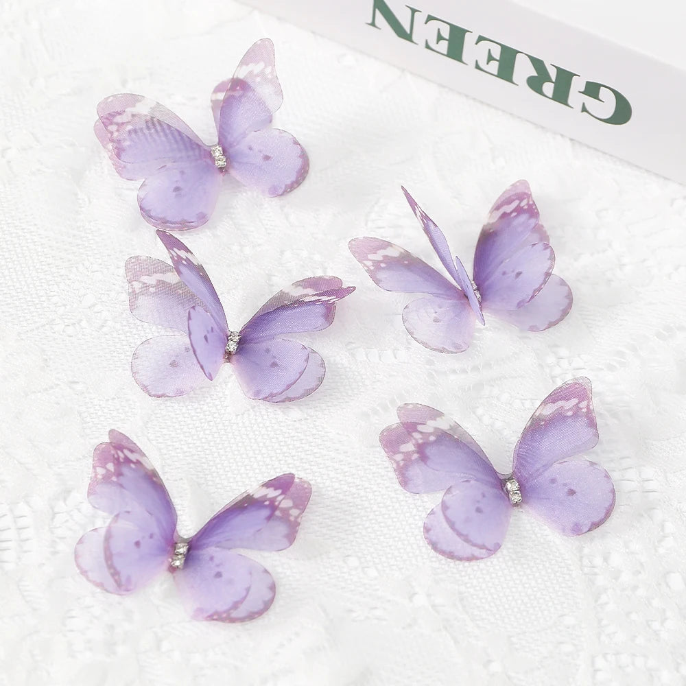 Several purple and lilac embroidered butterfly patches are displayed on white fabric.