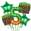 A set of green and gold miner-themed birthday party balloons and tableware.