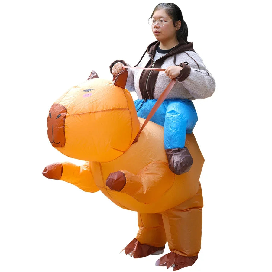 A woman is wearing an inflatable orange capybara costume that resembles a ride-on suit.