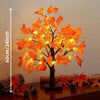 Un arbre de bouleau noir artificiel avec des feuilles d'automne orange vif illuminées par des lumières LED.