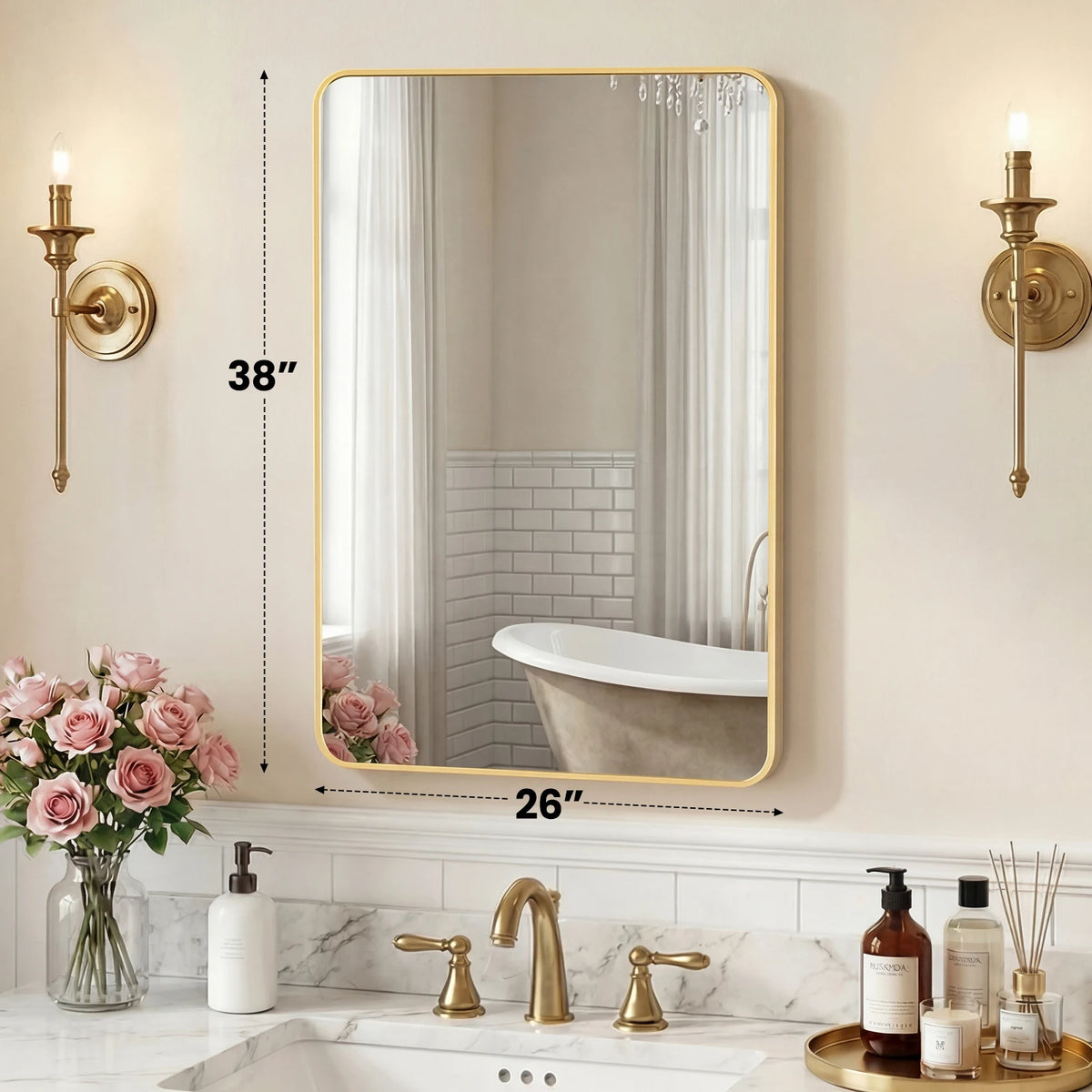 A modern wall mirror with a gold metal frame reflecting a bathroom interior and a bathtub.