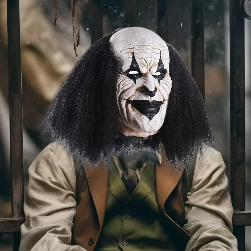 A close-up of a person wearing a full-face latex mask resembling a clown with dark hair and white face paint.