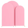 Three pink spandex fitted wedding arch covers standing upright.