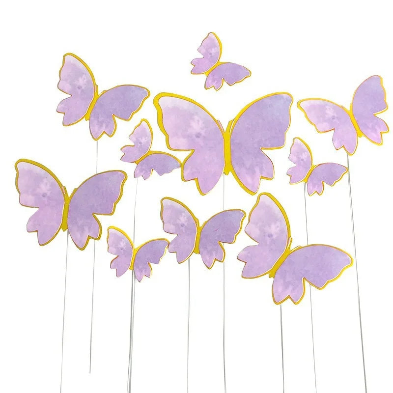 Elegant paper butterfly cake toppers in purple and gold.