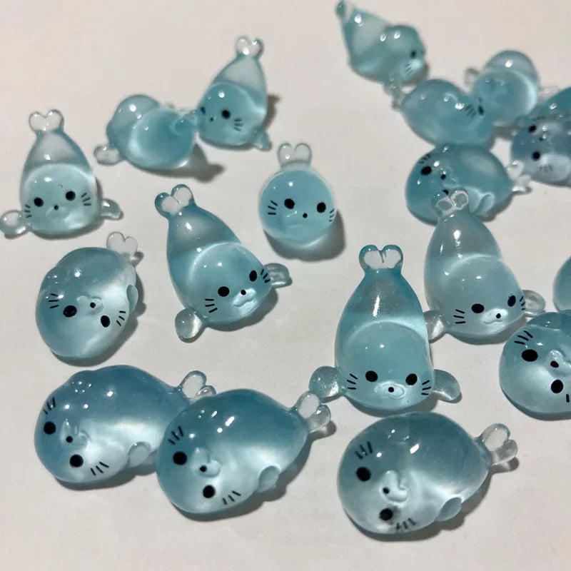 A collection of translucent blue glow in the dark resin sea animal figurines.