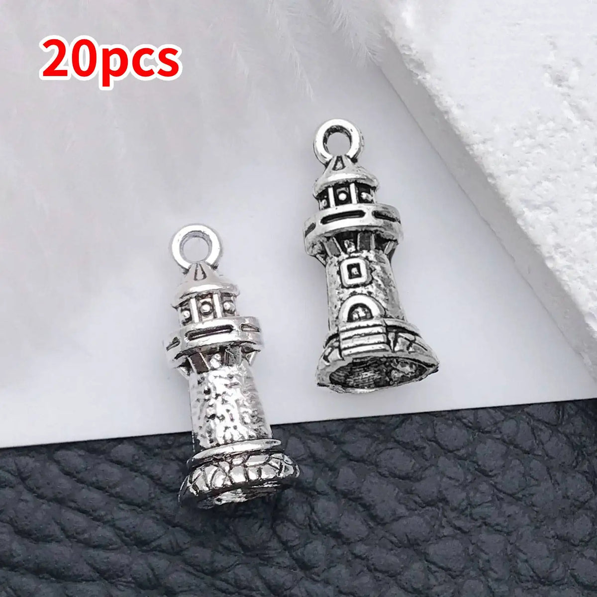 A set of 20 vintage ship anchor charms for jewelry making displayed on a dark surface.