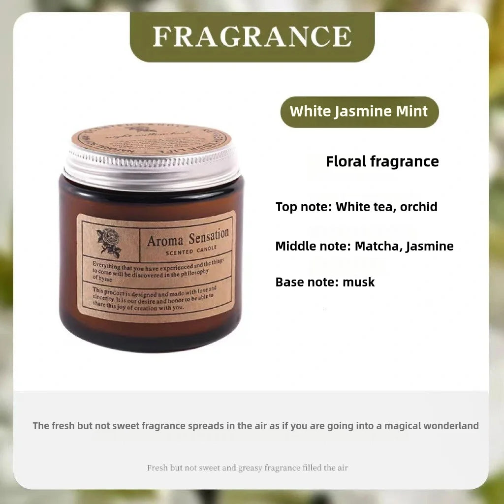 A jar of White Jasmine Mint floral fragrance candle with a silver lid and a label detailing the scent notes.