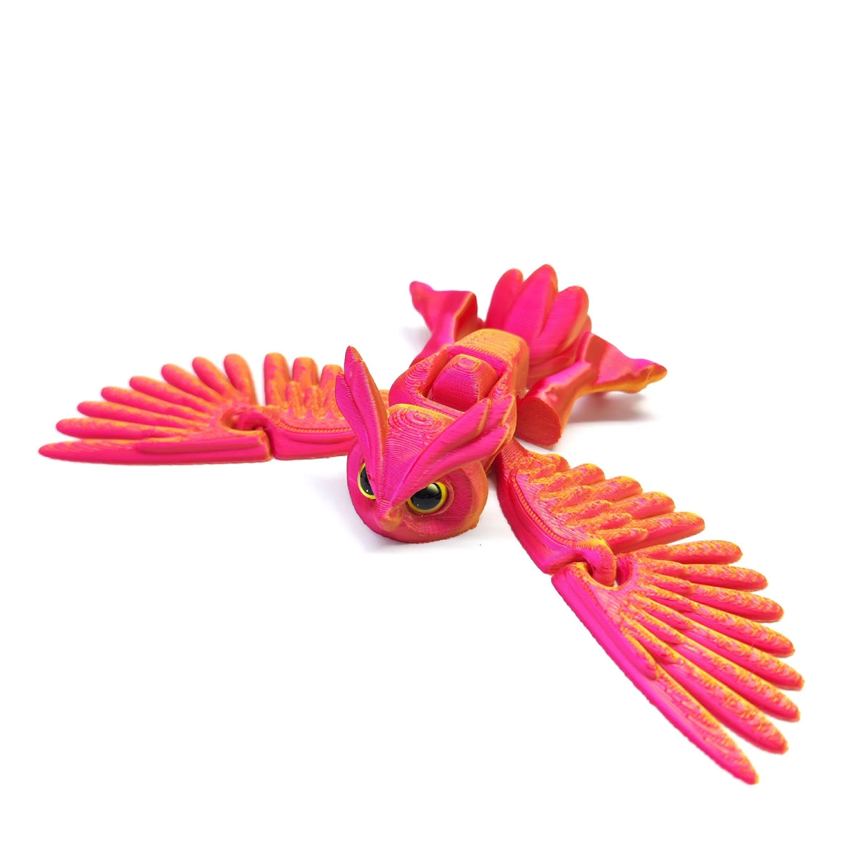 A vibrant pink articulated 3D printed owl figurine with outstretched wings and a detailed face.