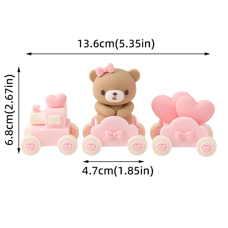 Pink baby blocks cake toppers featuring a bear and a car design