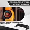 A black wall mount holder displaying a yellow die-cast car model.