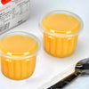 A clear disposable dessert cup filled with a yellow-orange jelly or dessert, shown next to a spoon.