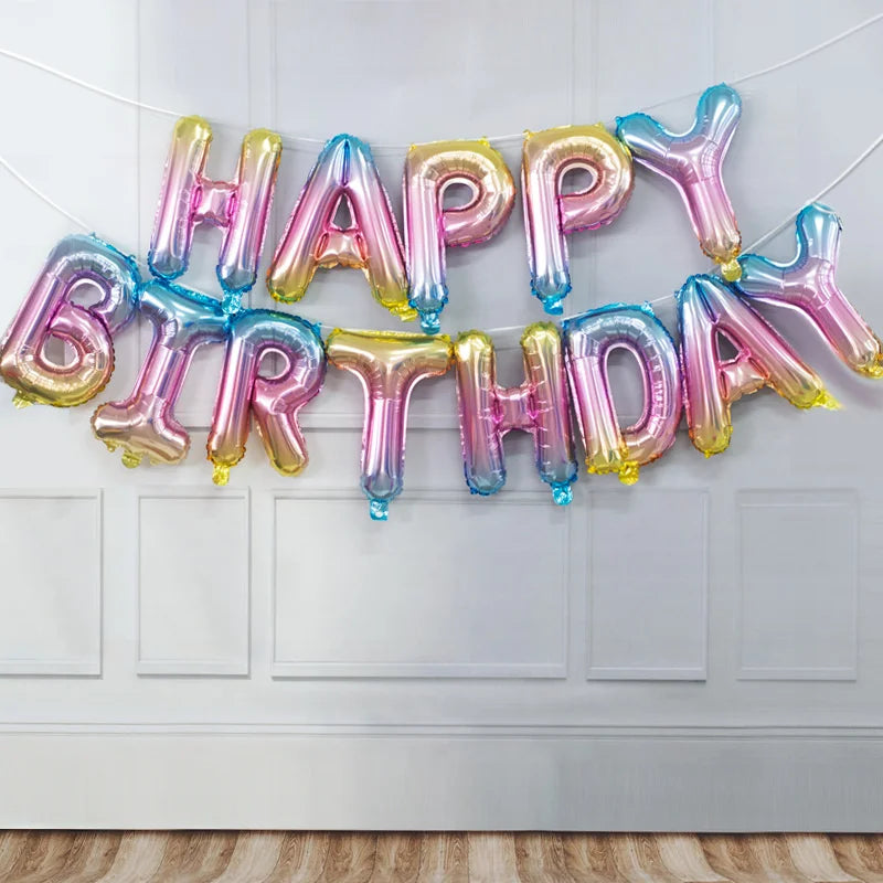 A garland of 13 foil letter birthday balloons spelling out HAPPY BIRTHDAY across a white door.