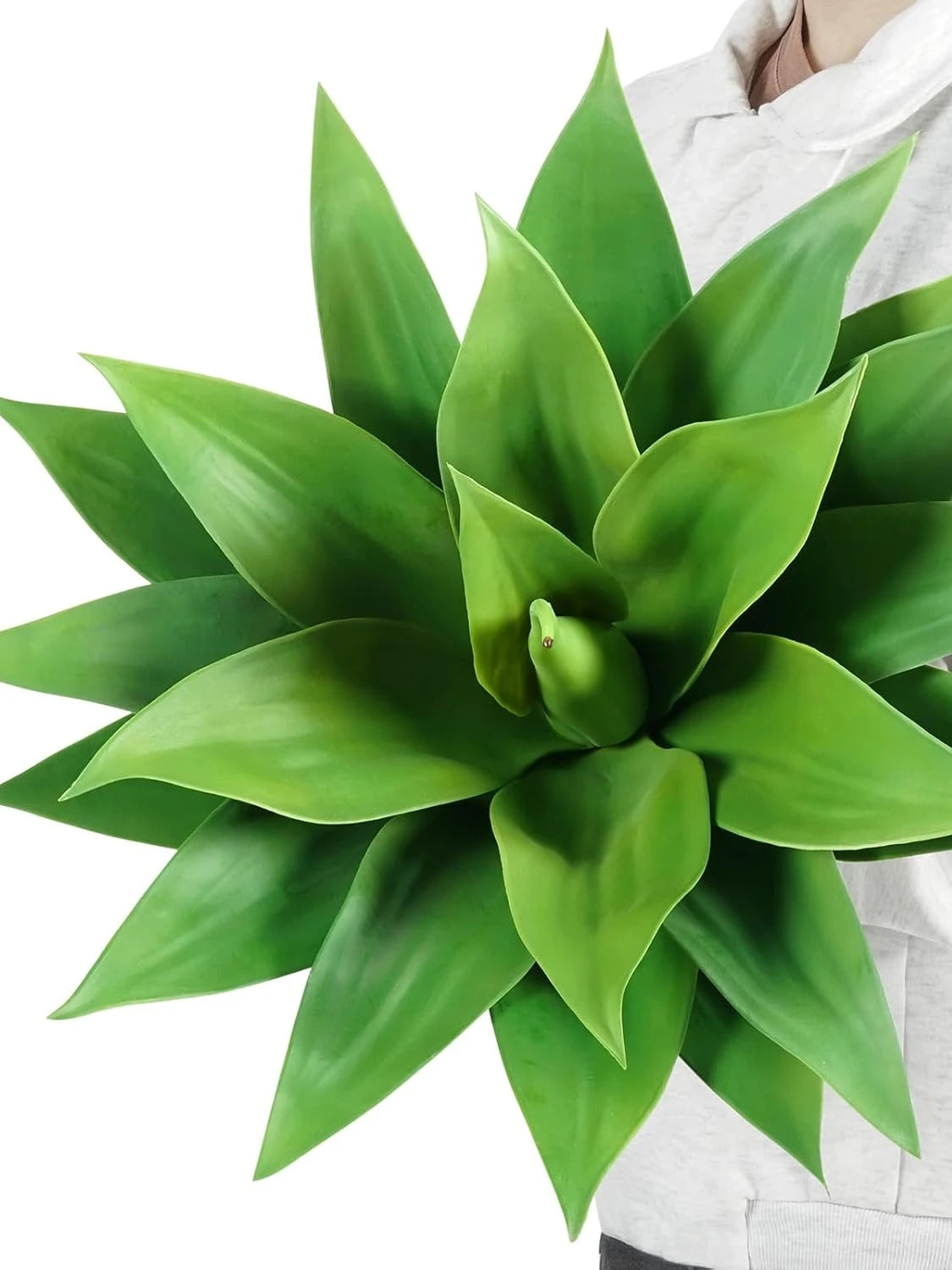 A vibrant green artificial agave plant with thick, fleshy leaves is shown against a white background.