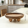 A round wooden storage tray with a lip and a base, used for aromatherapy or essentials.