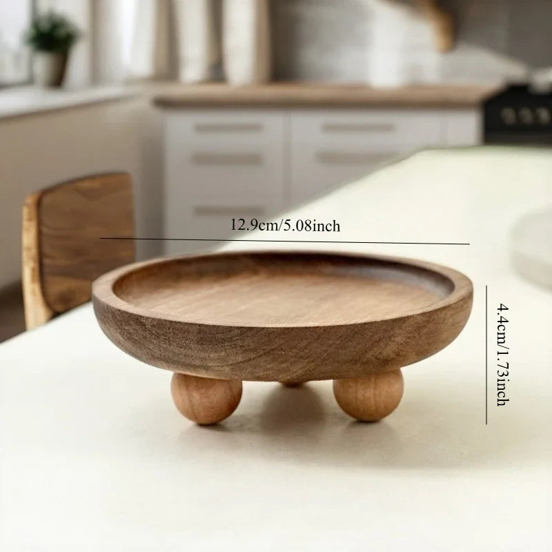 A round wooden storage tray with a lip and a base, used for aromatherapy or essentials.