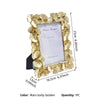 A gold leaf border photo frame with a white insert and black backing.