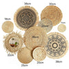 A collection of round boho straw wall hangings in various sizes and patterns.
