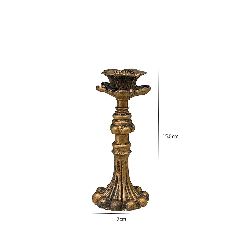 Vintage resin wall sconce candle holder with a fluted base and decorative leaves.