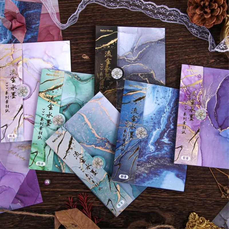 A collection of gradient wash retro decorative paper cards in purple, blue, and green tones scattered on a dark wooden surfac