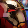 Close-up of a metallic red and gold Iron Man MK5 wearable helmet with glowing red LED lights.