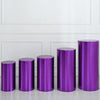 A row of five metallic purple cylinder stands used as covers for weddings and events.