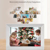 A white digital photo frame displaying a family enjoying a Christmas scene, with small photos arranged above it.