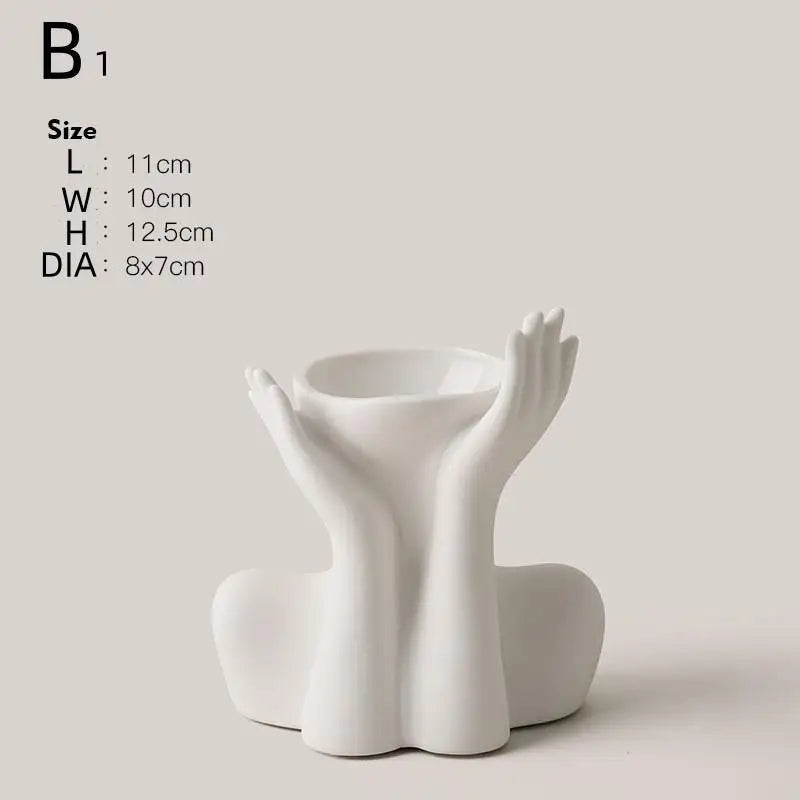 A white ceramic figural vase shaped like an artistic human form.