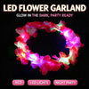 A glowing red LED flower garland worn as a crown or headband for a night party.
