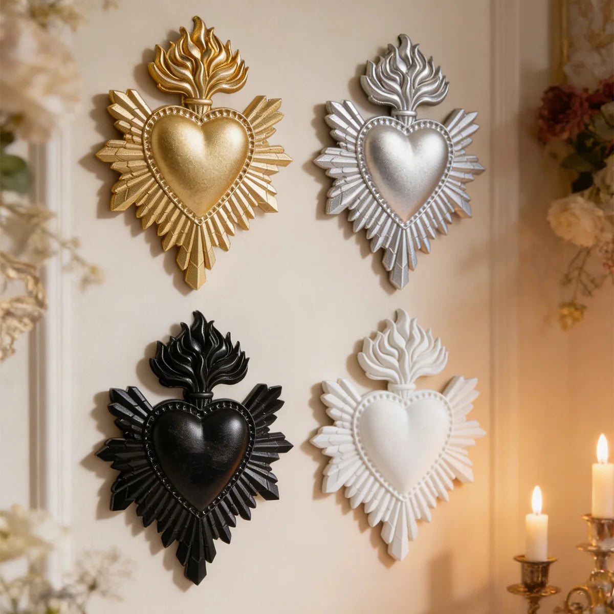 A collection of four decorative heart-shaped wall plaques made of gold, silver, black, and white resin.