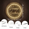 A round, glowing neon sign spelling Happy Birthday mounted on a dark brown surface with accessory details.