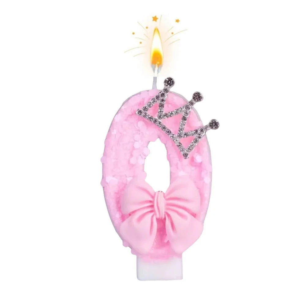 Pink bow crown birthday candles set with a lit candle and sparkling crown detail