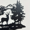 Black silhouette wall art featuring a deer standing in front of a dense forest and mountain backdrop.