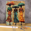 A paint by numbers kit featuring three portraits of African women, painted in vibrant colors on textured paper.