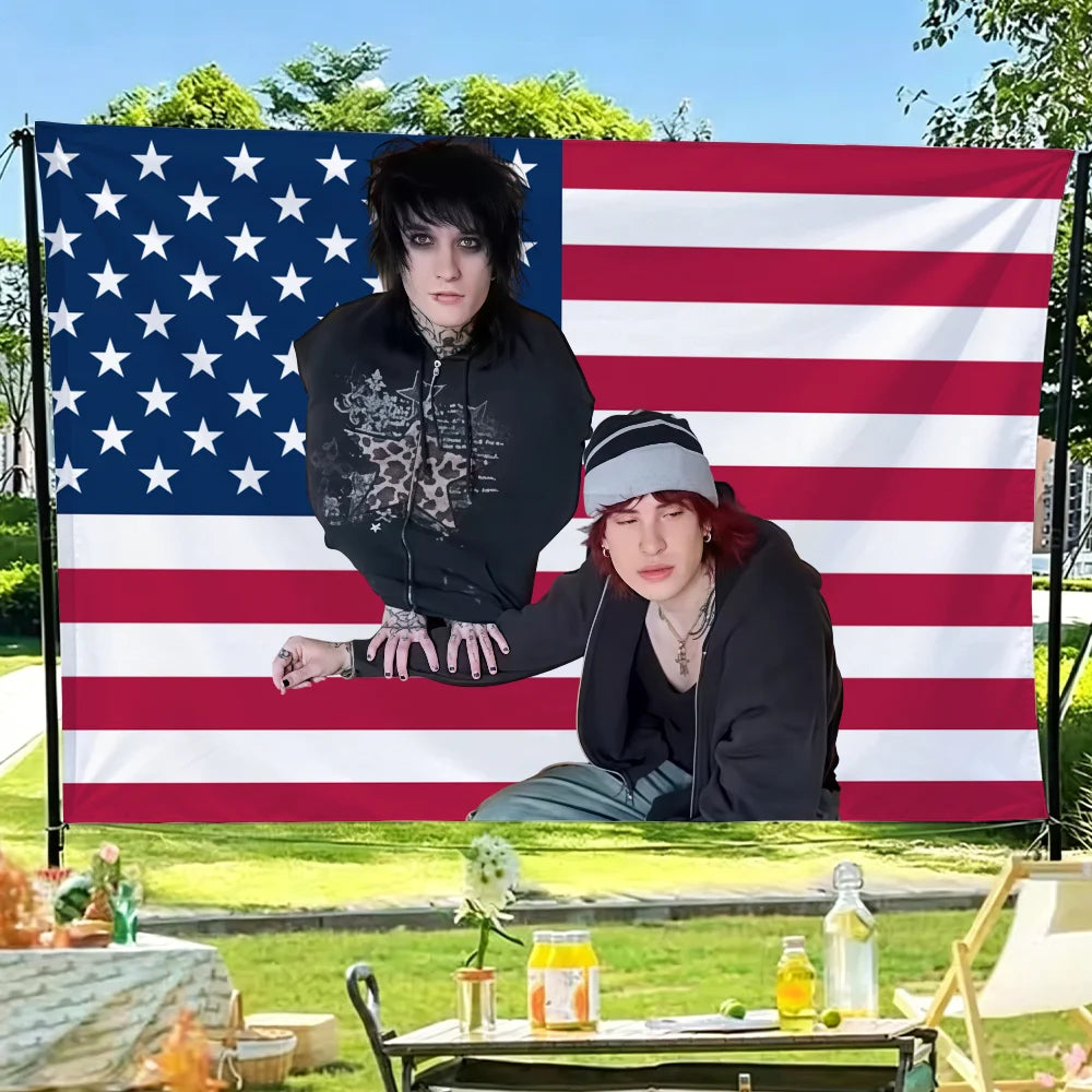 A photo of Jake Webber and Johnnie Guilbert tapestry wall hanging displayed on an American flag backdrop.