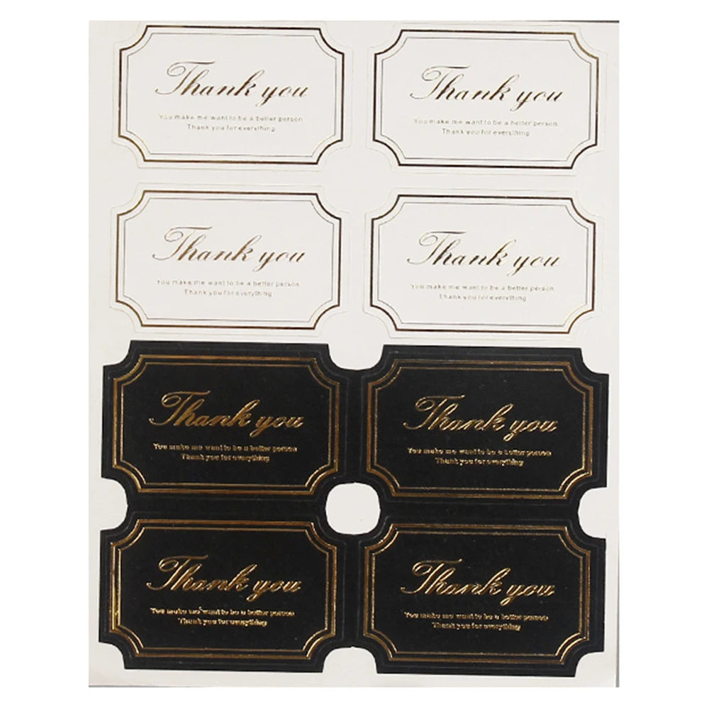A sheet of thank you seal stickers in black and gold for crafting and packaging.