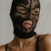 A woman wearing a black Venetian Gothic lace mask covering her eyes and nose.