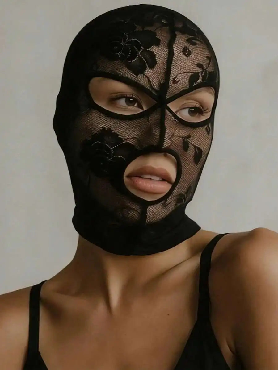 A woman wearing a black Venetian Gothic lace mask covering her eyes and nose.
