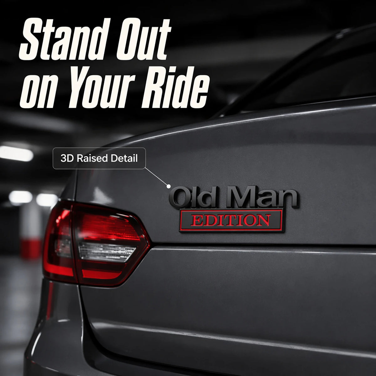 A close-up of a dark gray car's taillight showing an Old Man Edition 3D raised detail emblem.