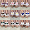 A set of ruffled lace wrist cuffs with bowknot accents in various shades of purple, pink, and blue.