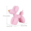 A pink resin sculpture of a dog shaped like a balloon, displayed with dimension lines.