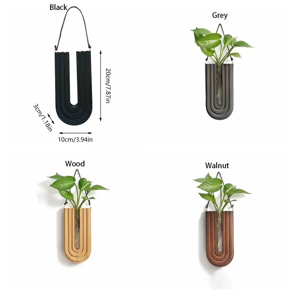 Four wall-mounted hydroponic plant vases in black, grey, wood, and walnut finishes.