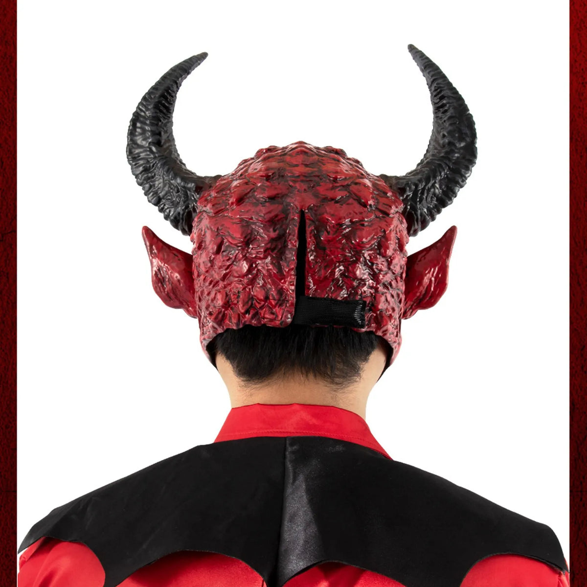 Back view of a realistic devil head mask with black horns and red textured material, worn by a person.